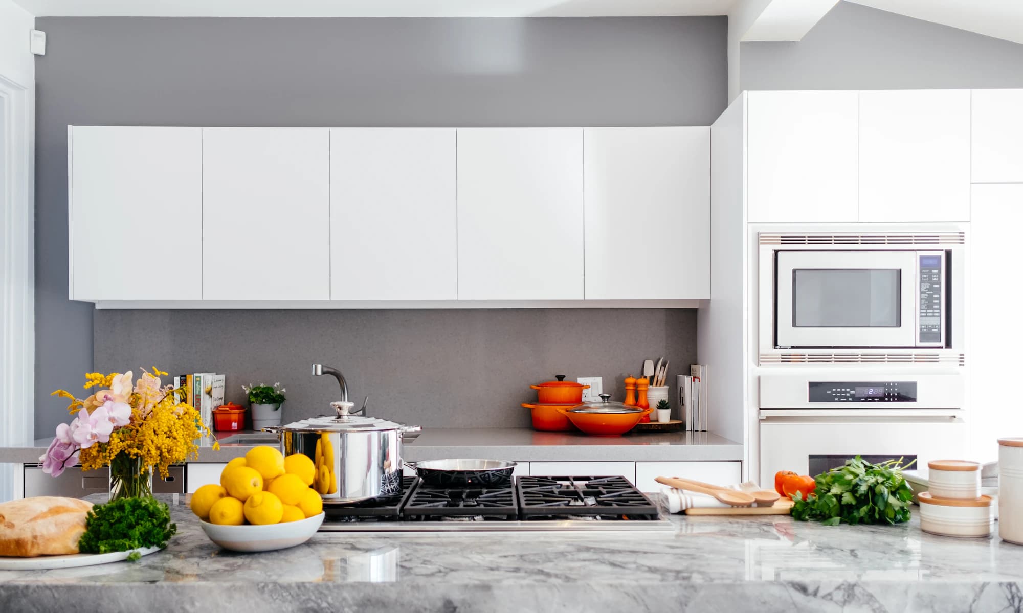 A bright kitchen counter with stainless cookware at Oreste Utensils